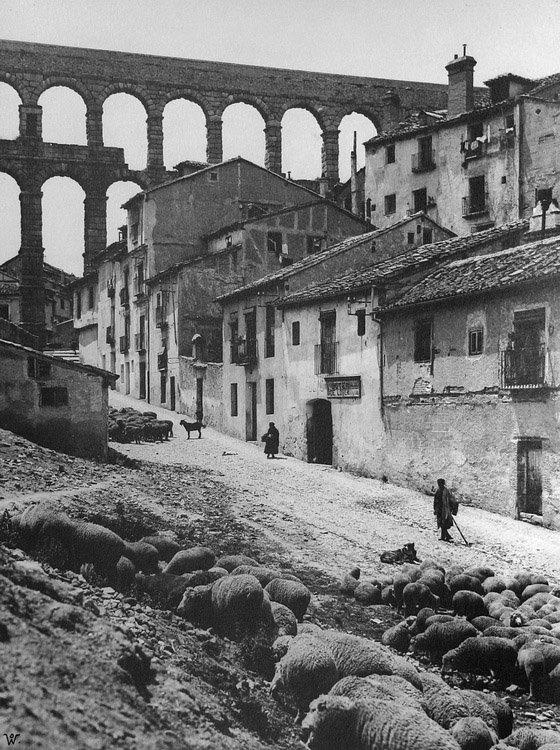 Shepherd in front of Roman Aquaduct, Segovia, Spain. 1920