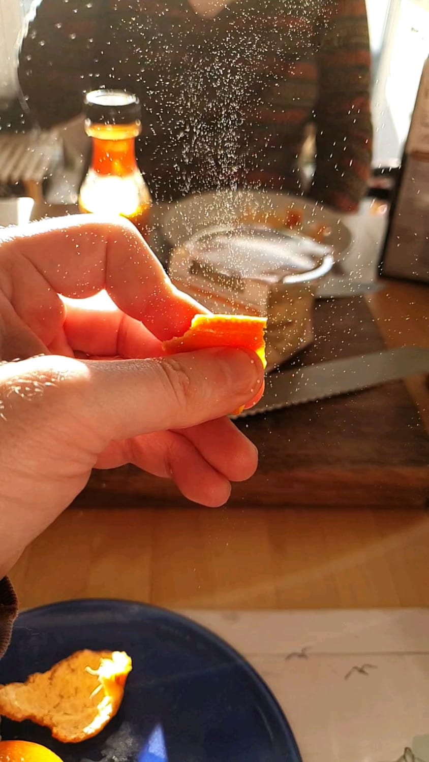 Squeezing orange peel in the sunlight