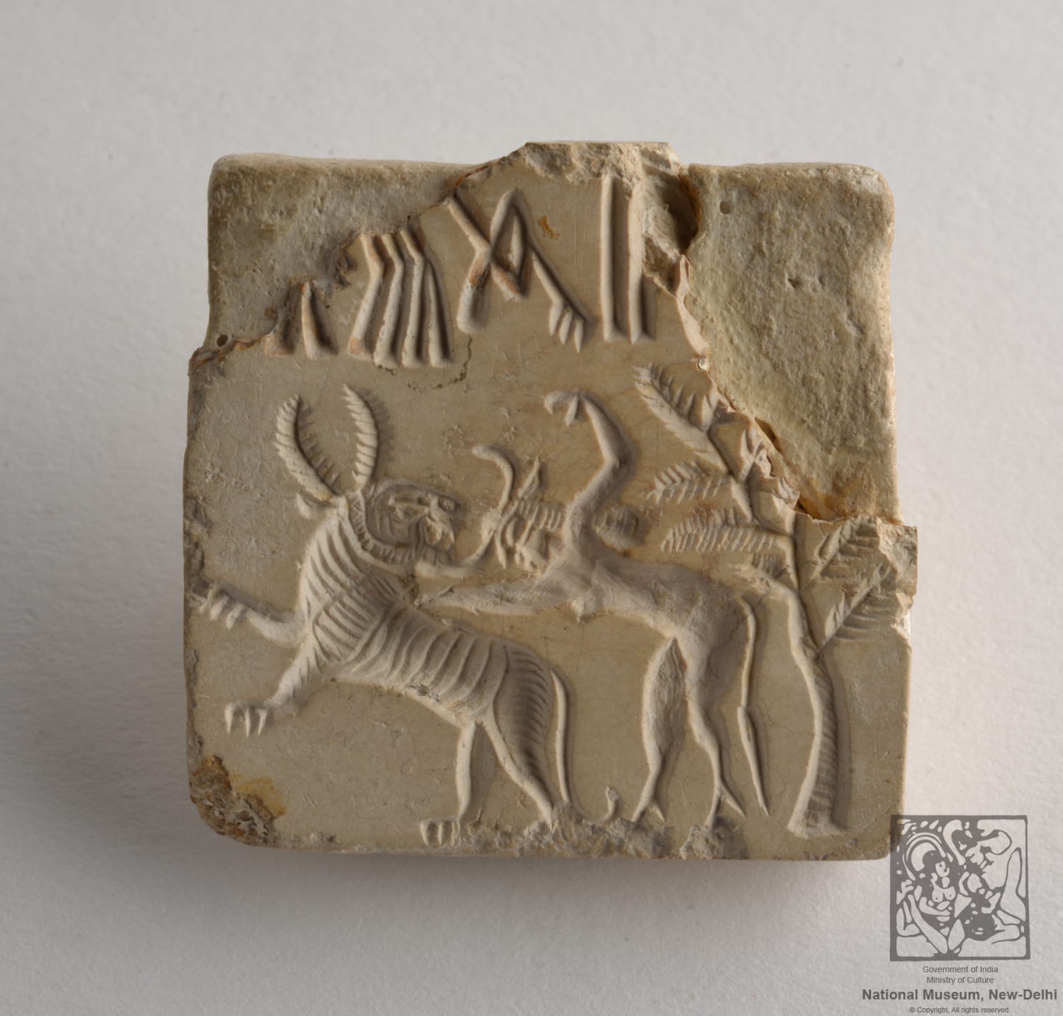 Seal showing a human fighting tiger including tree and four pictograms, 2500-2000 BCE, Mohenjodaro, Indus Valley Civilization, National Museum, New Delhi, India.