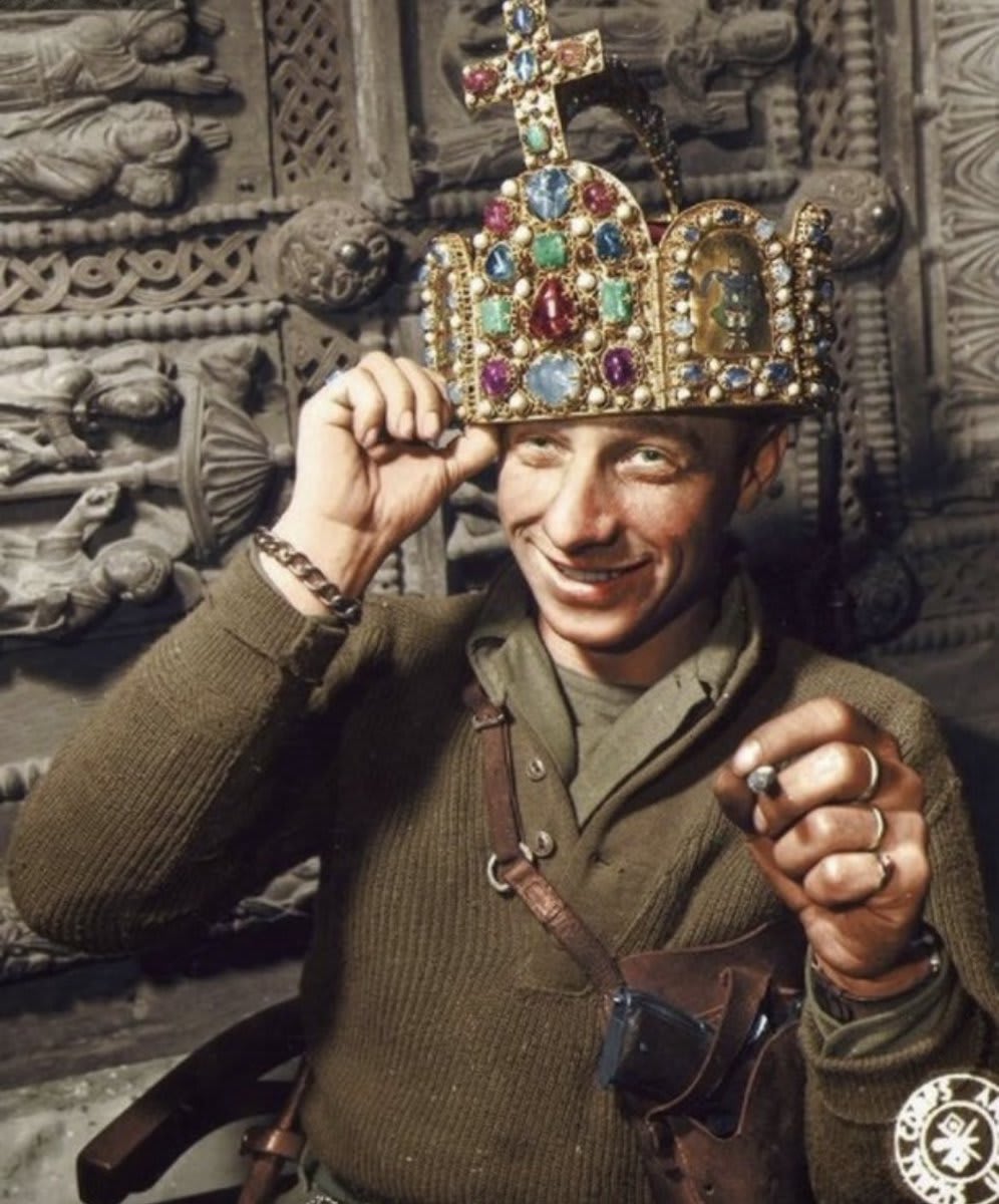 Ivan Babcock of the US Army's 165th Signal Photo Company Poses with the Crown of the Holy Roman Empire in a cave in Siegan, Germany, 3 April 1945.