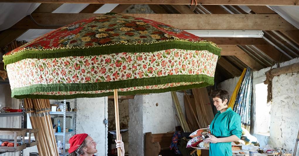 Garden parasols made from vintage fabric in a 12th century grain store in Cornwall