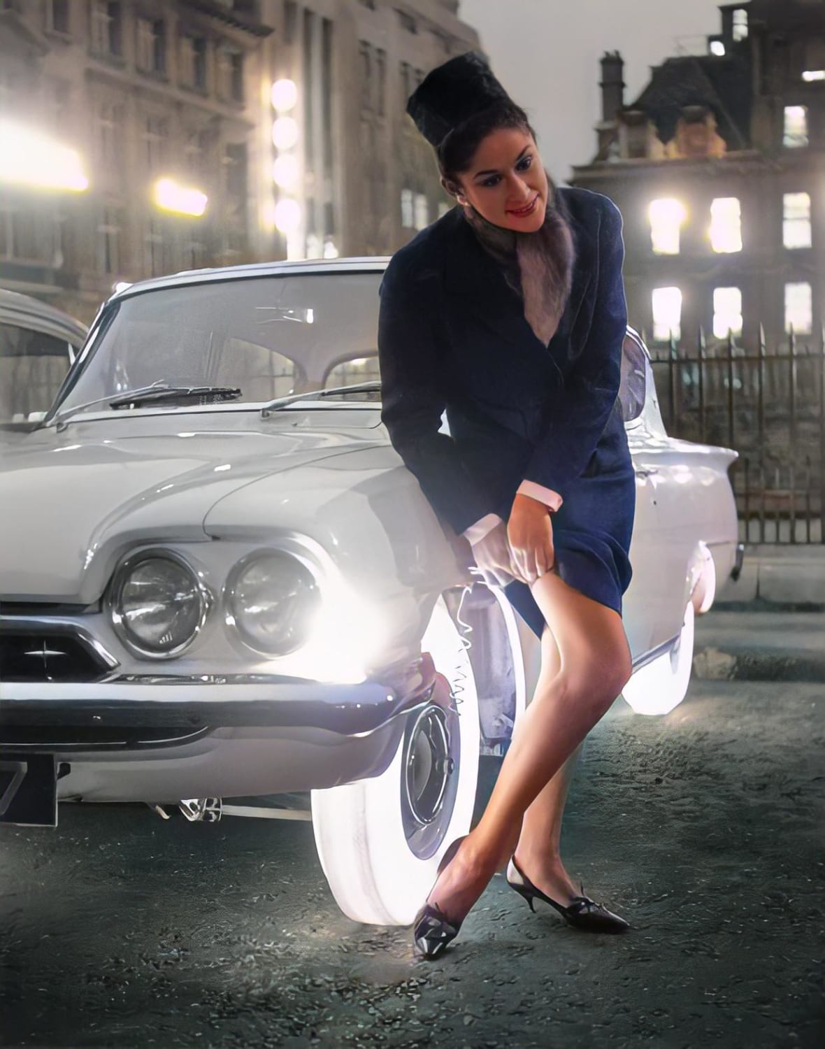 A stylish woman adjusts herself by the light of Goodyear's Neothane tyres (1960's, colourized)
