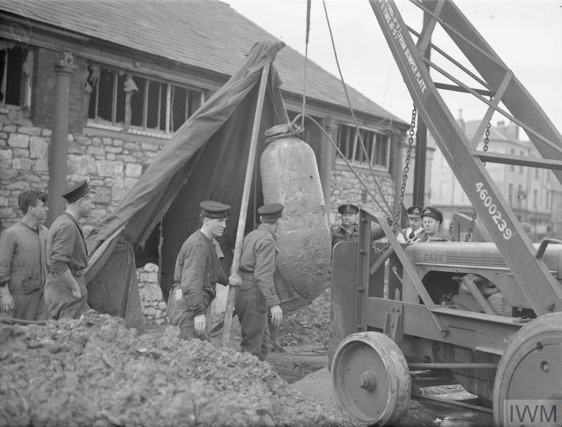 Easy does it... A naval bomb disposal team dig up and remove a 1000 kilogram, unexploded bomb in Devonport, Plymouth, onthisday 1943. © IWM A 13947