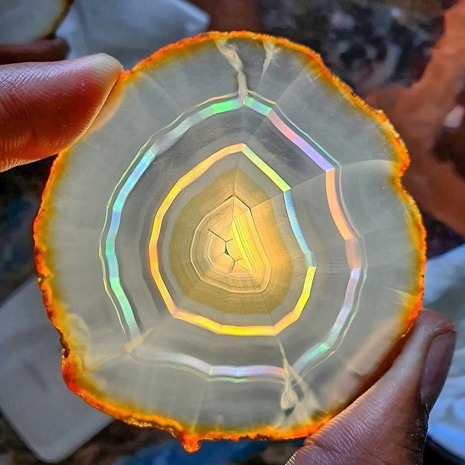 A stunning iris Agate slice from brazil! due to very fine banding within the stone, light passing through is refracted, resulting in bands of rainbows!