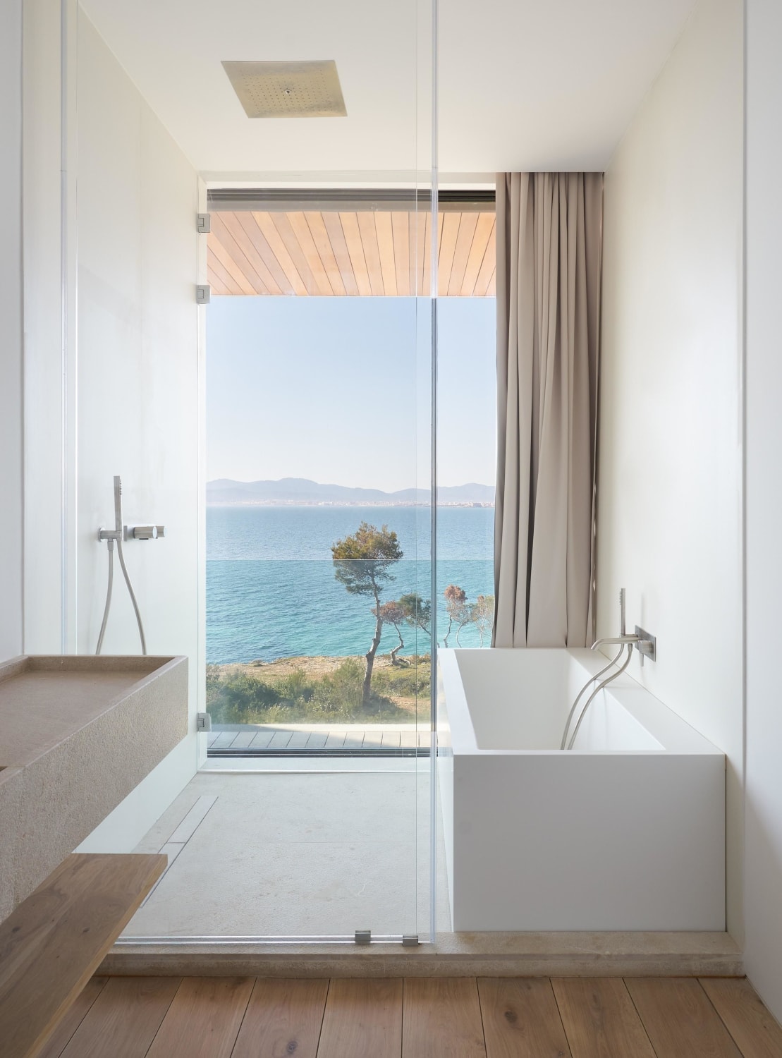 Bathroom opening up to outdoor deck with views toward Bay of Palma, Mallorca, Spain by Jorge Bibiloni Studio