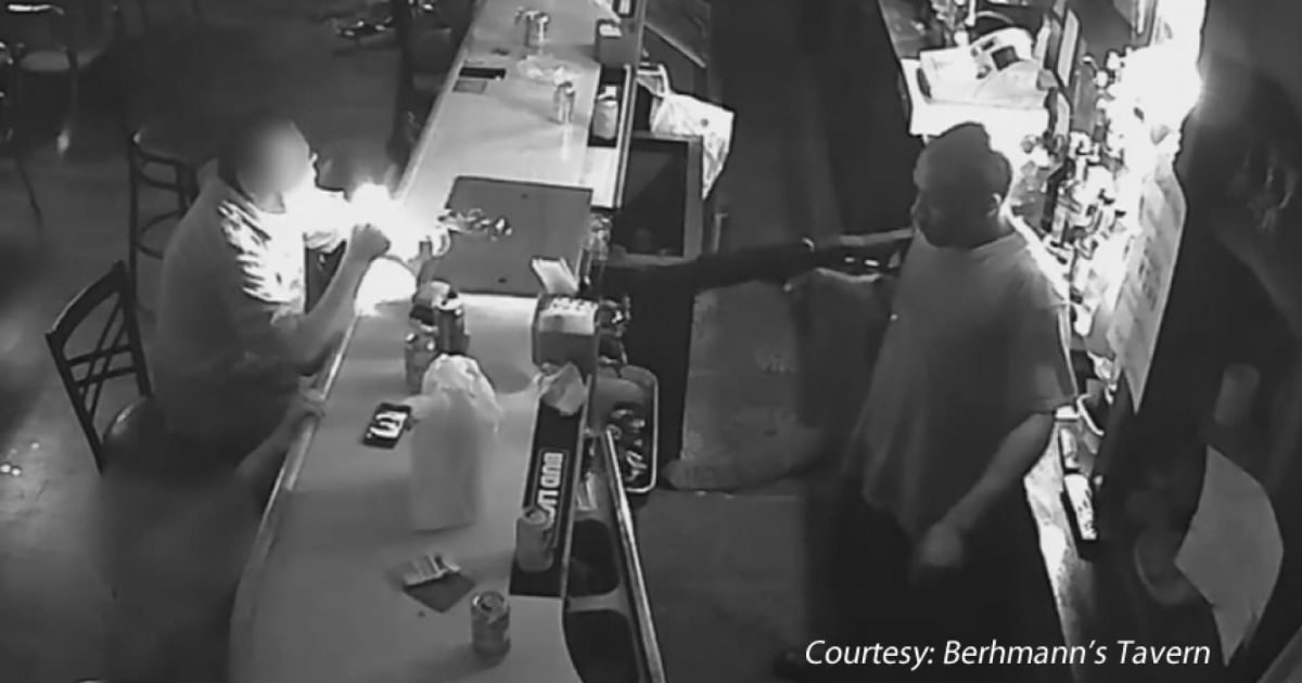 Man in St. Louis bar lights cigarette while ignoring armed robber (Worth suffering through the commercial)