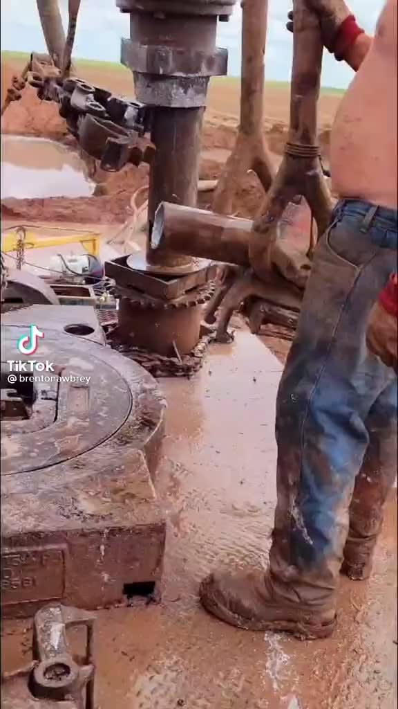 Workers getting an oil rig ready to drill