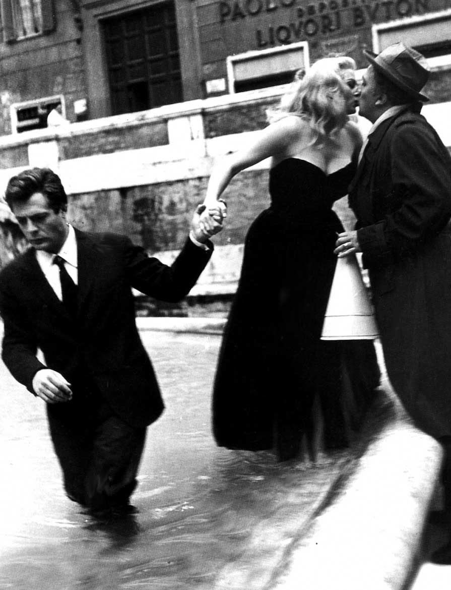 Fellini gets a kiss from Anita Ekberg while filming "La Dolce Vita" (1960). Sorry, Marcello.
