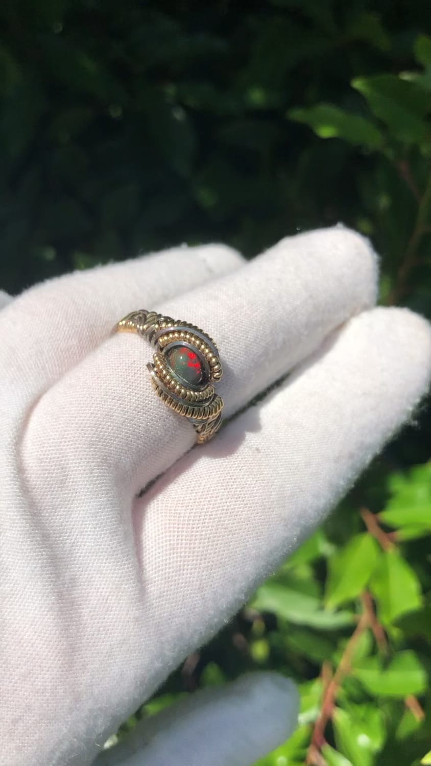 I wire wrapped this Opal ring using 14k gold filled wire with some oxidized sterling silver additions and some crystal surprises on the bottom band!