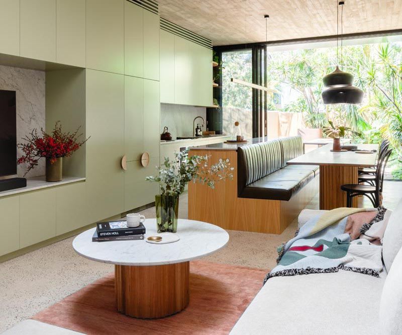 This Kitchen Island Saves Space In A Narrow Interior By Including Built-In Banquette Seating