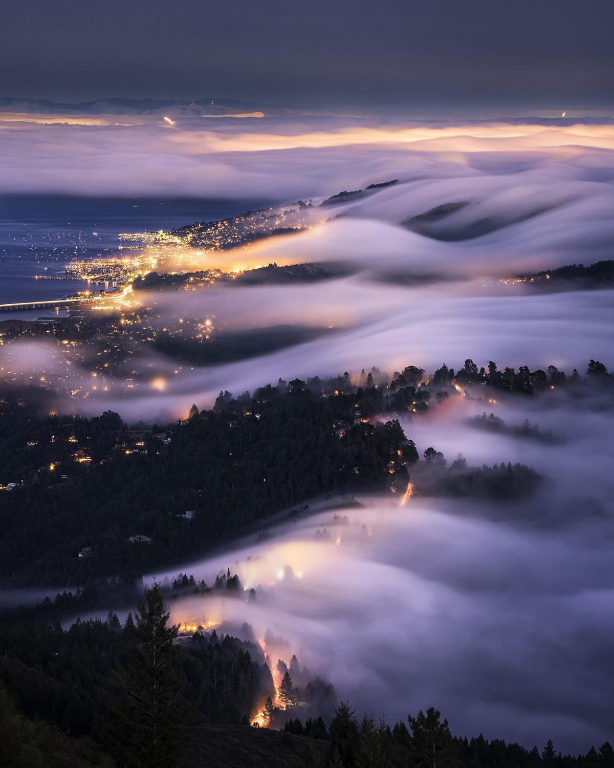 Fog rolls over the hills into the city of Sausalito, CA