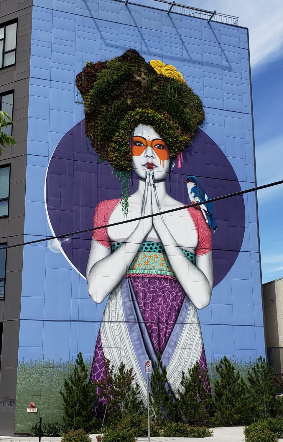 This mural has real plants for hair