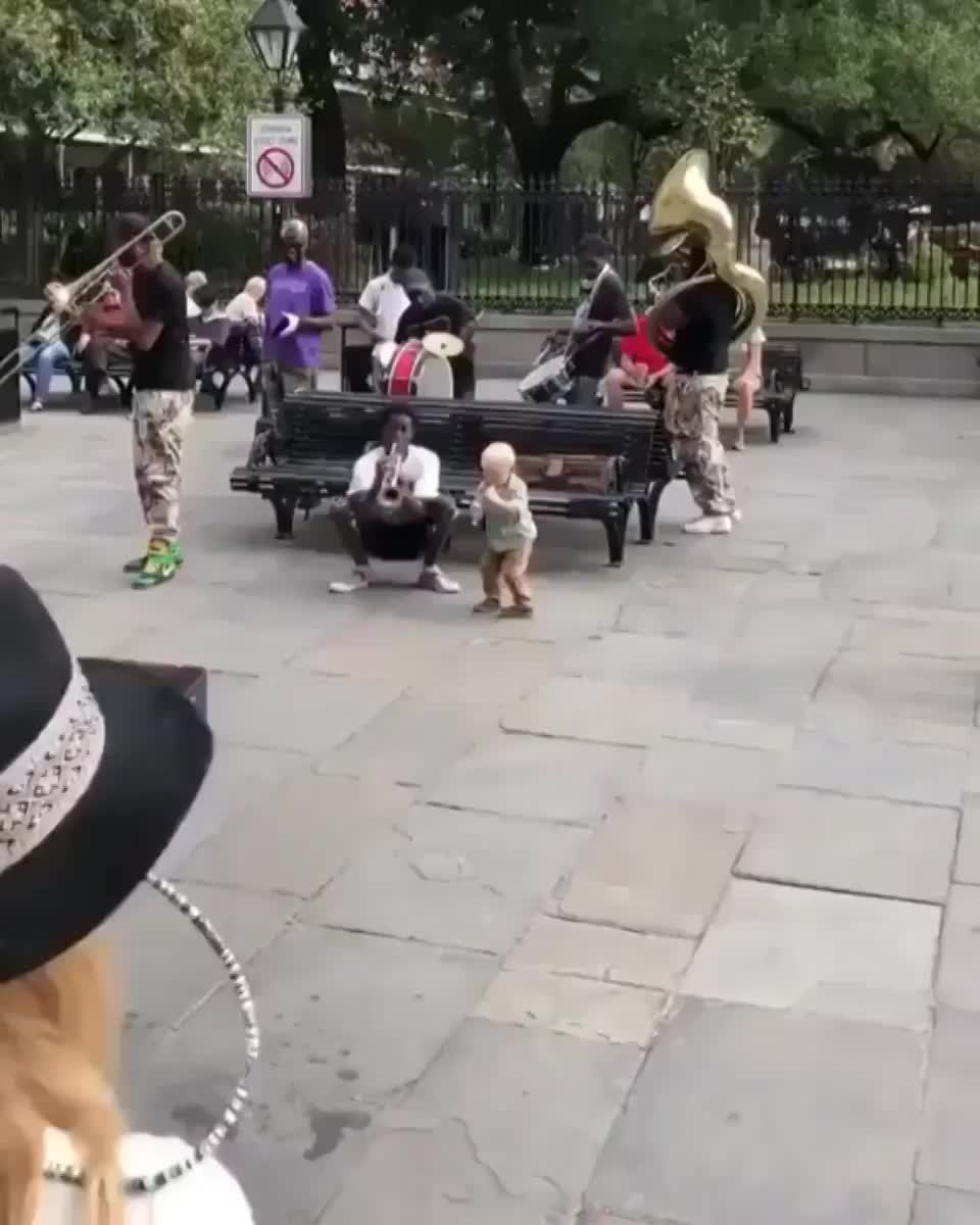 Little kid plays his heart out with street musicians.
