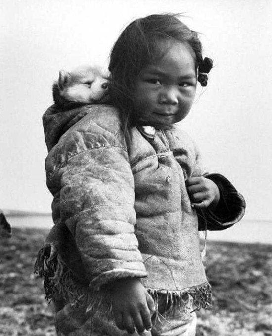 A young Inuit girl with her dog, 1949