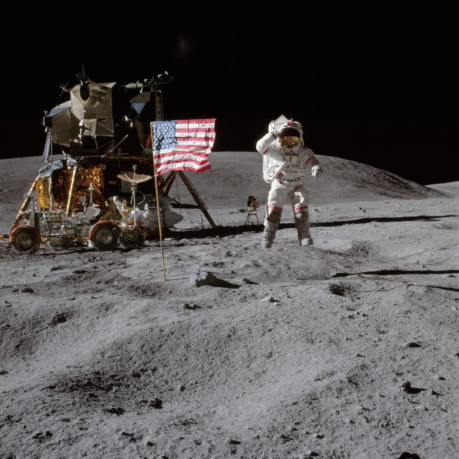 Astronaut John W. Young, commander of the Apollo 16 lunar landing mission, leaps from the lunar surface as he salutes the United States flag at the Descartes landing site during the first Apollo 16 extravehicular activity (EVA).