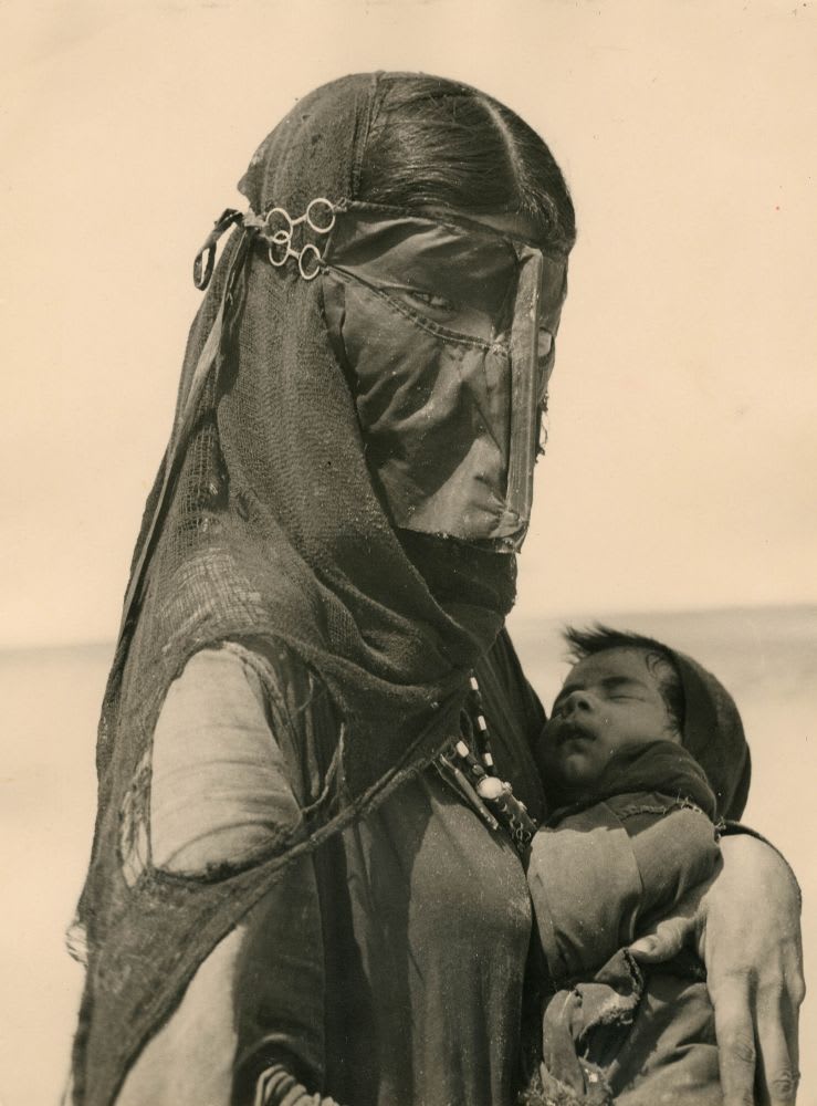 Bedouin woman and her child, Saudi Arabia, 1940s.