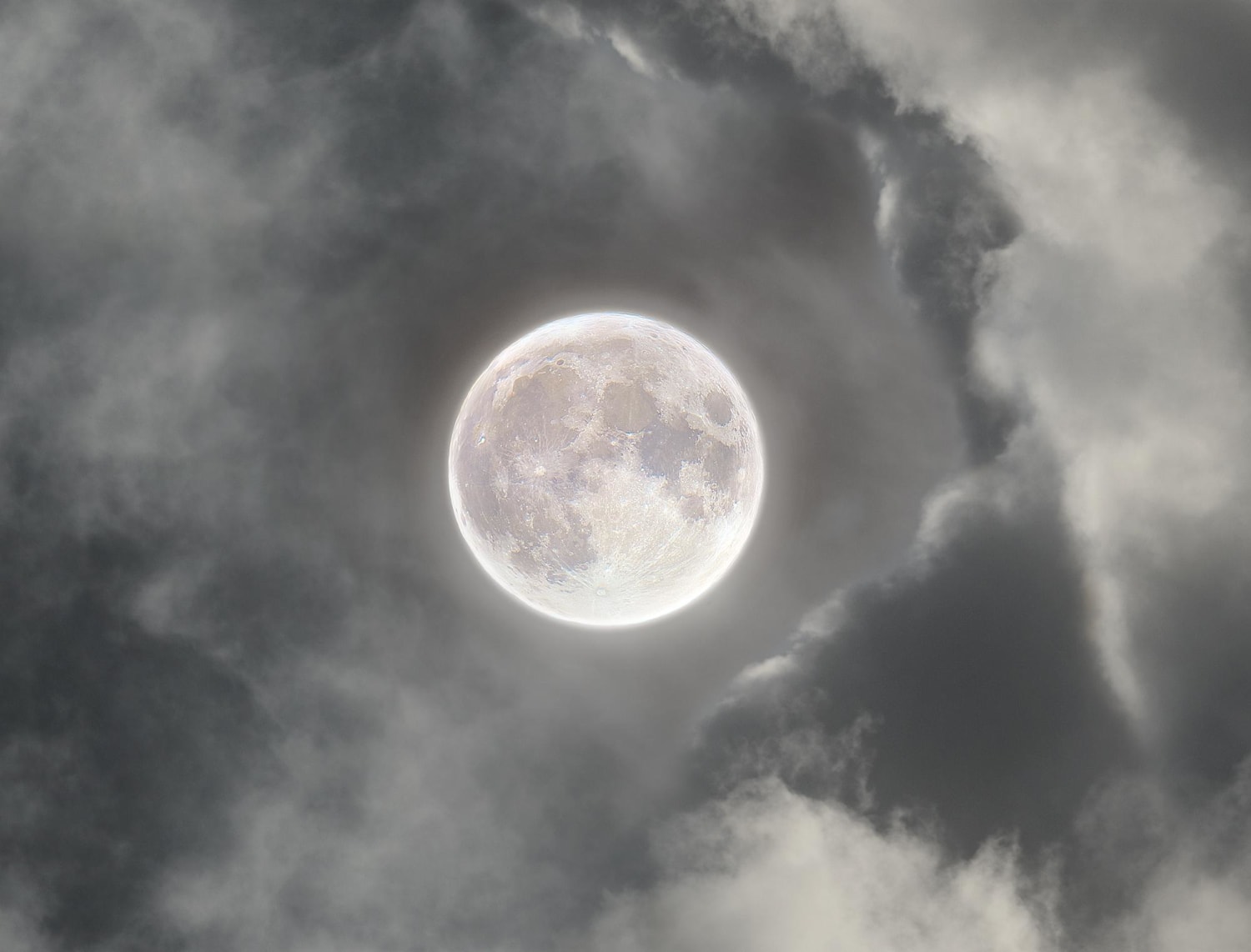 I took 500gb worth of photos of the moon through the clouds and stacked them to show detail