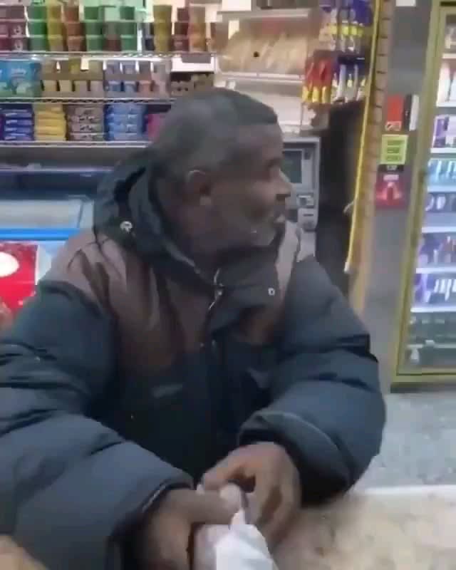 Shopkeeper gives food and drink to homeless guy
