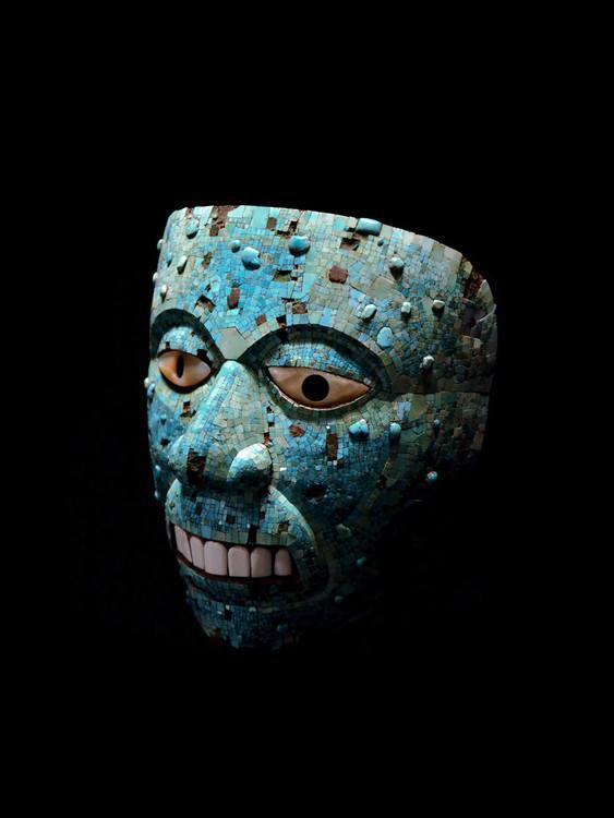 An Aztec Turquoise mosaic mask representing Xiuhtecuhtli, the god of fire, 1400-1521 CE. The mask is of cedar with mother-of-pearl eyes and conch shell teeth. The British Museum.