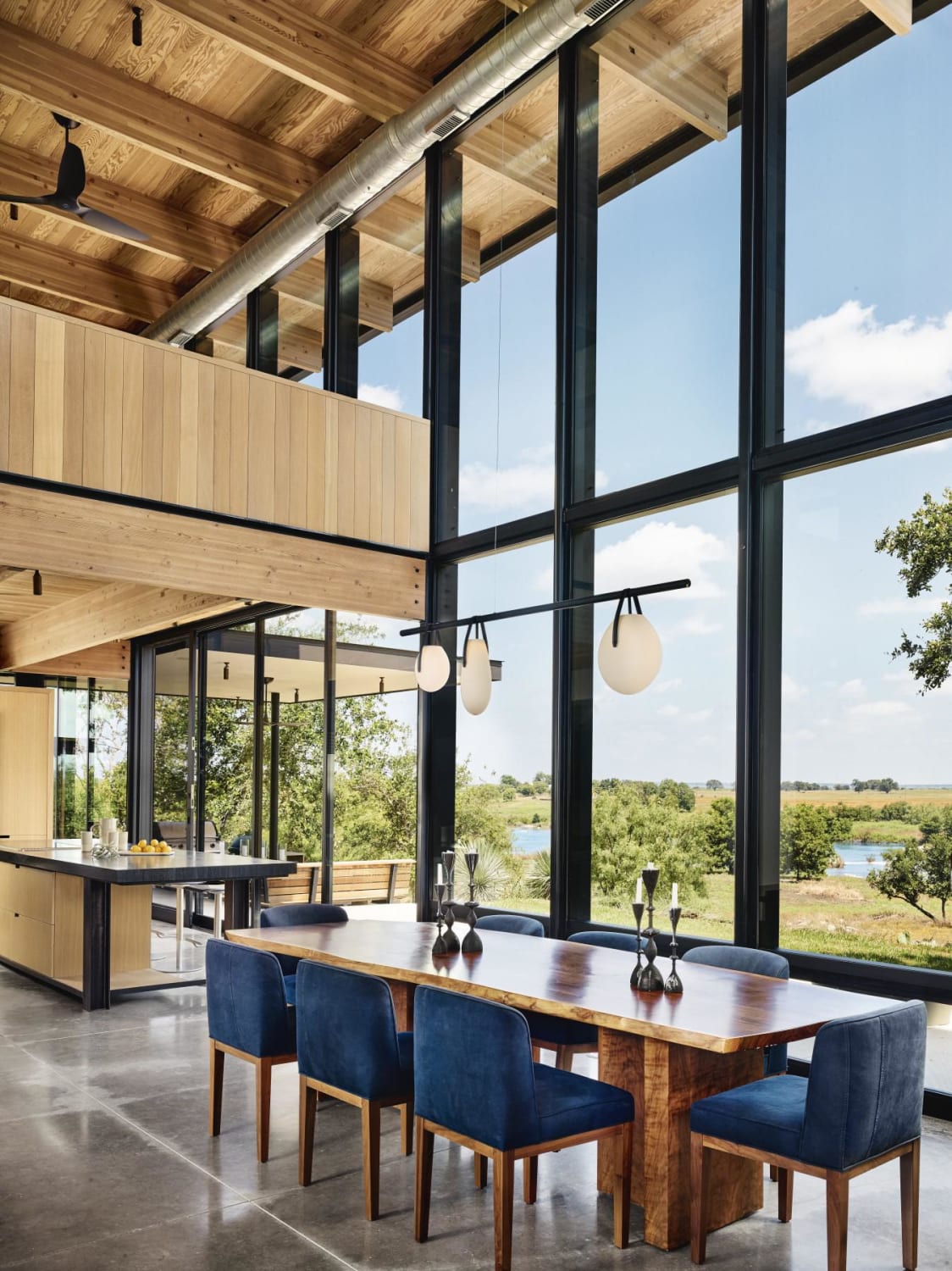 Dining area with double-height Douglas fir ceiling opening up to views of the river, Mason, Texas by Michael Hsu Office of Architecture (Photo: Casey Dunn)