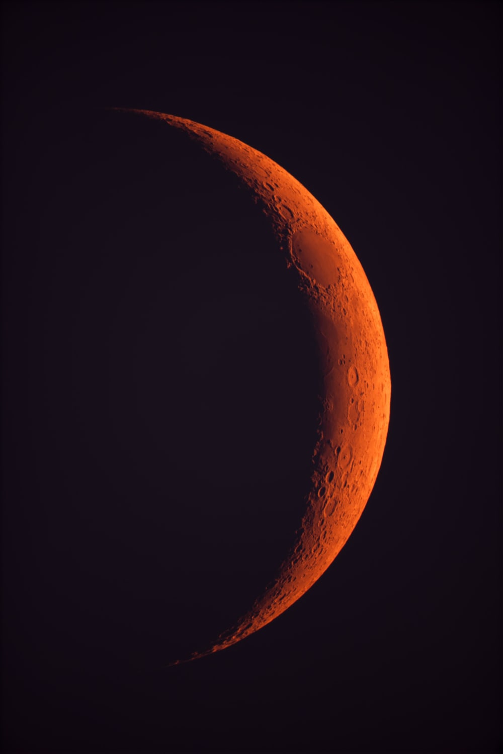The fires in northern California are so bad that we all were sent home from work yesterday. Those same unhealthy particles in the air are causing light from the sun/moon to scatter way more than normal, turning them red. Here is the moon last night, color unedited.
