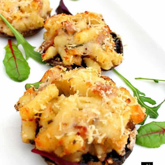 Mac N Cheese Stuffed Mushrooms is so delicious! Easy to make and great for parties or as an appetizer. Baked mushrooms stuffed with a creamy macaroni and cheese filling with bacon too!