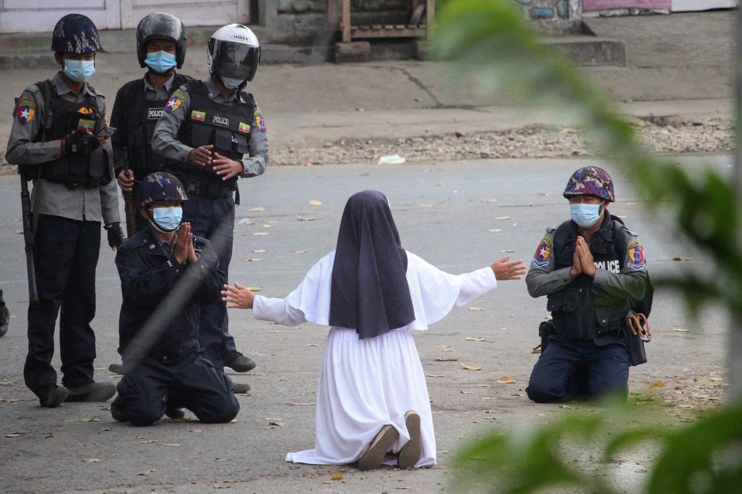A nun in Myanmar kneeled in front of police begging them not to attack protesters: "Kill me instead." Police shot at protesters anyway, killing at least 2. She said she saw a "young kid's head had exploded and... a river of blood on the street." (Photo: Myitkyina News Journal)