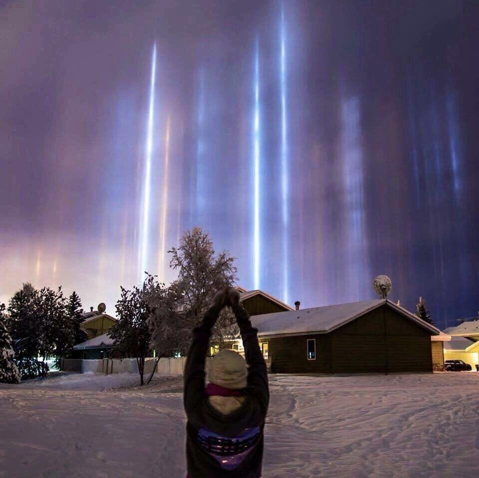 Light pillars in Alaska. This happened when reflection of light from tiny ice crystals are suspended in the atmosphere
