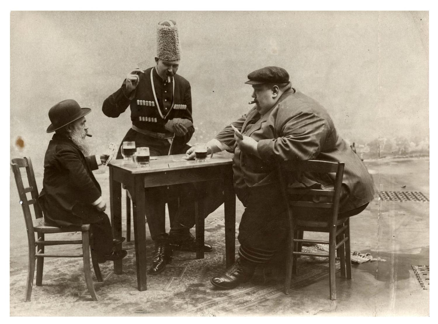 The tallest, shortest and fattest men in Europe play cards together, 1913.