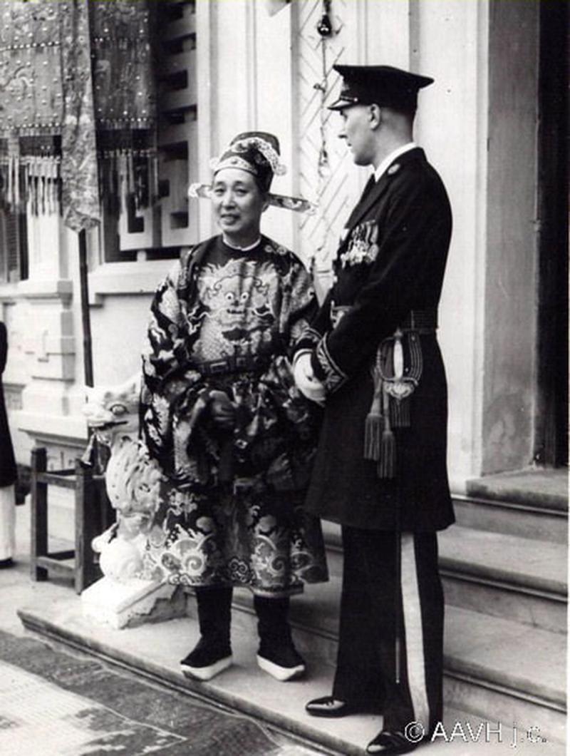 A Vietnamese Mandarin in Traditional Court Attire Standing with French commander Jean Haelewyn, 1939
