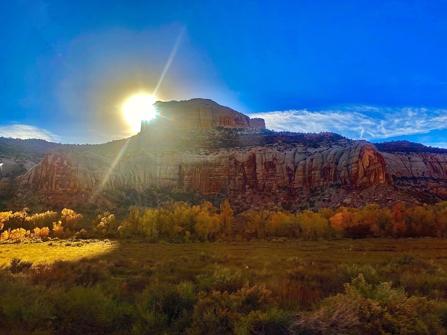 Sun playing peek-a-boo in Canyonlands National Park, Moab Utah