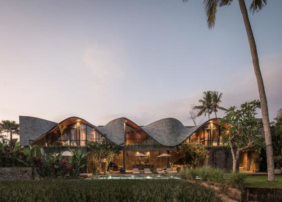 Twisted roof becomes walls and facade in Alpha House designed by Alexis Dornier in Bali