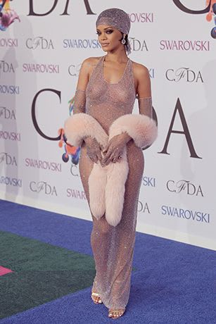Pop Artist, Rihanna, at the CFDA Awards 2014. She's wearing a sheer evening gown covered in Swarovski crystals. | Fashion event, Rihanna, Celebrity outfits