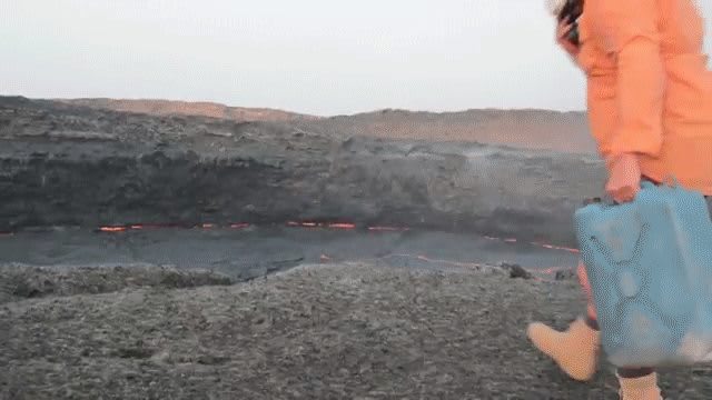 Tossing a container of water into a crater of lava