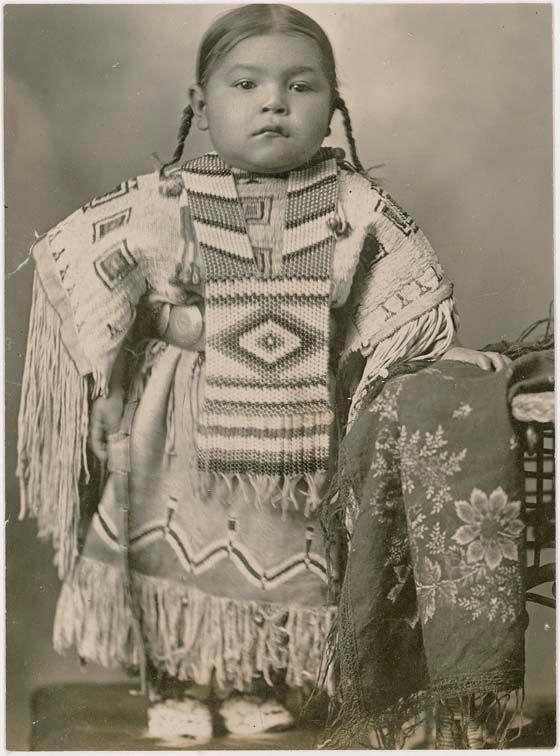 Cheyenne girl wearing an elaborate beaded dress and breastplate, 1915. Oklahoma.
