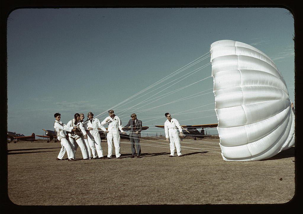 Original color photograph of an instructor explaining the operation of a parachute to student pilots at Meacham Field in Fort Worth, Texas. January 1942