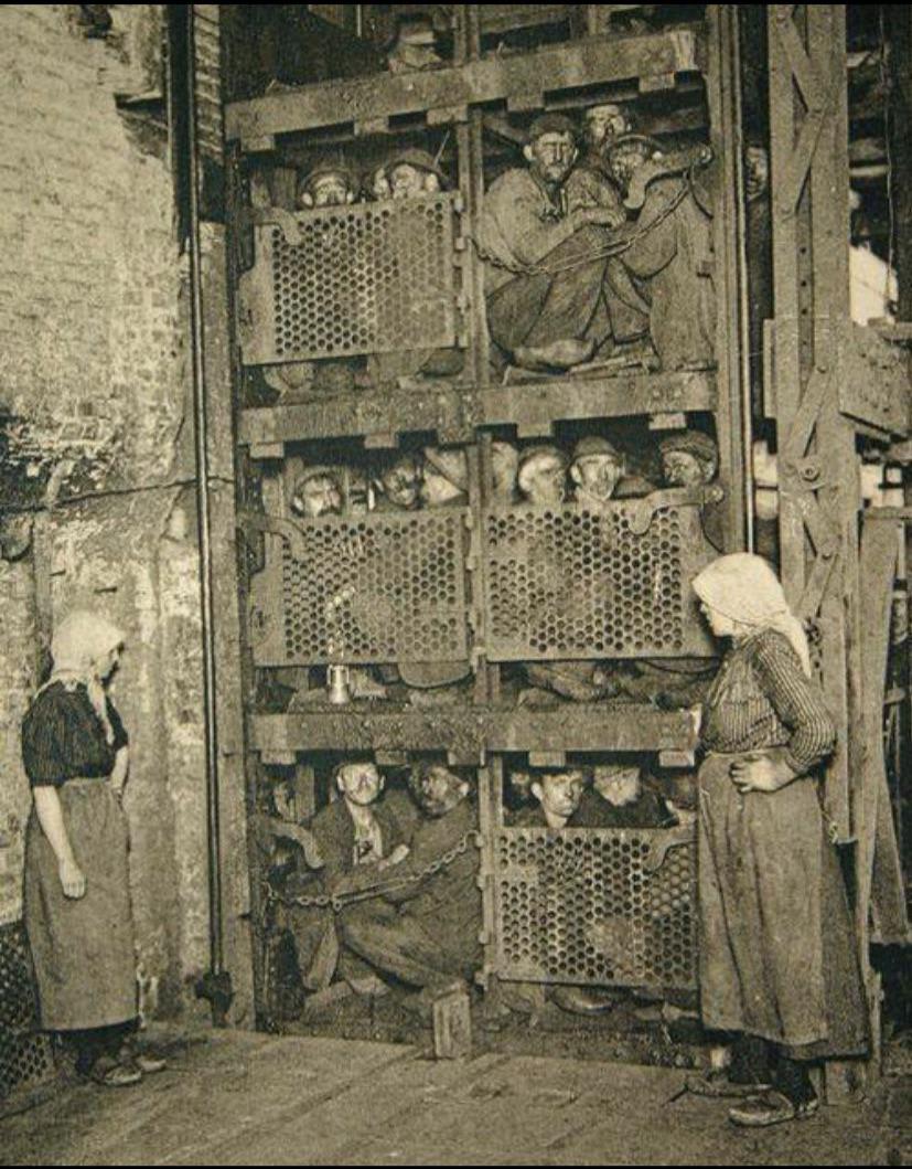 Belgian coal miners packed in a mine elevator, 1900.