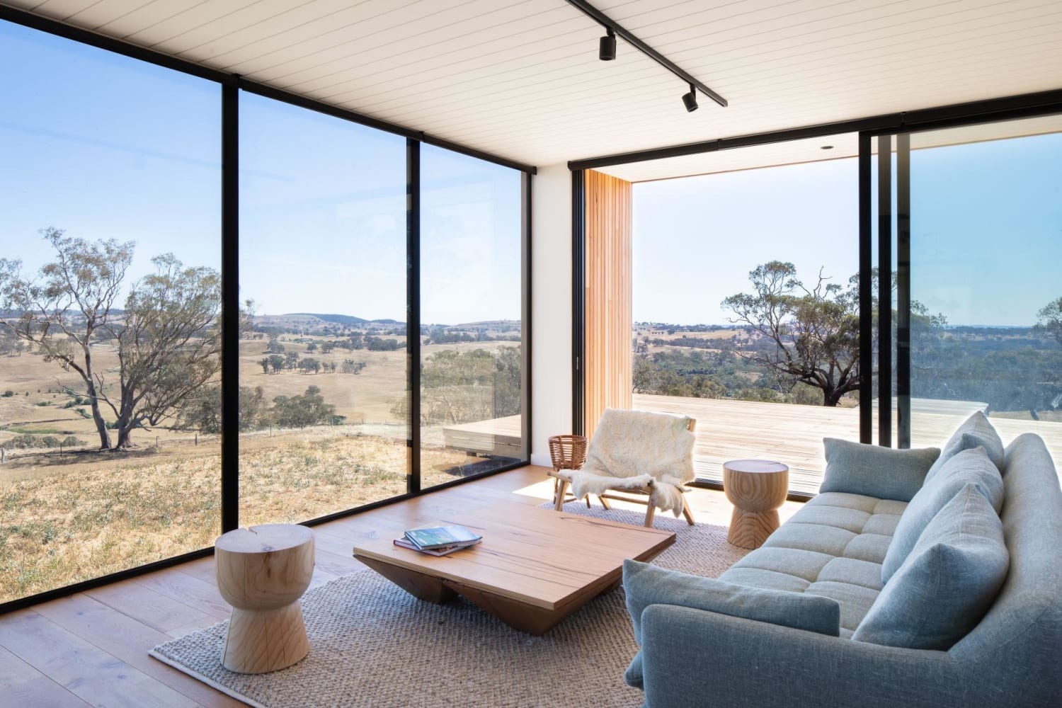 Living space in a modular prefab home opening up to a private deck with views towards Mount Canobolas, Orange, Australia by Modscape