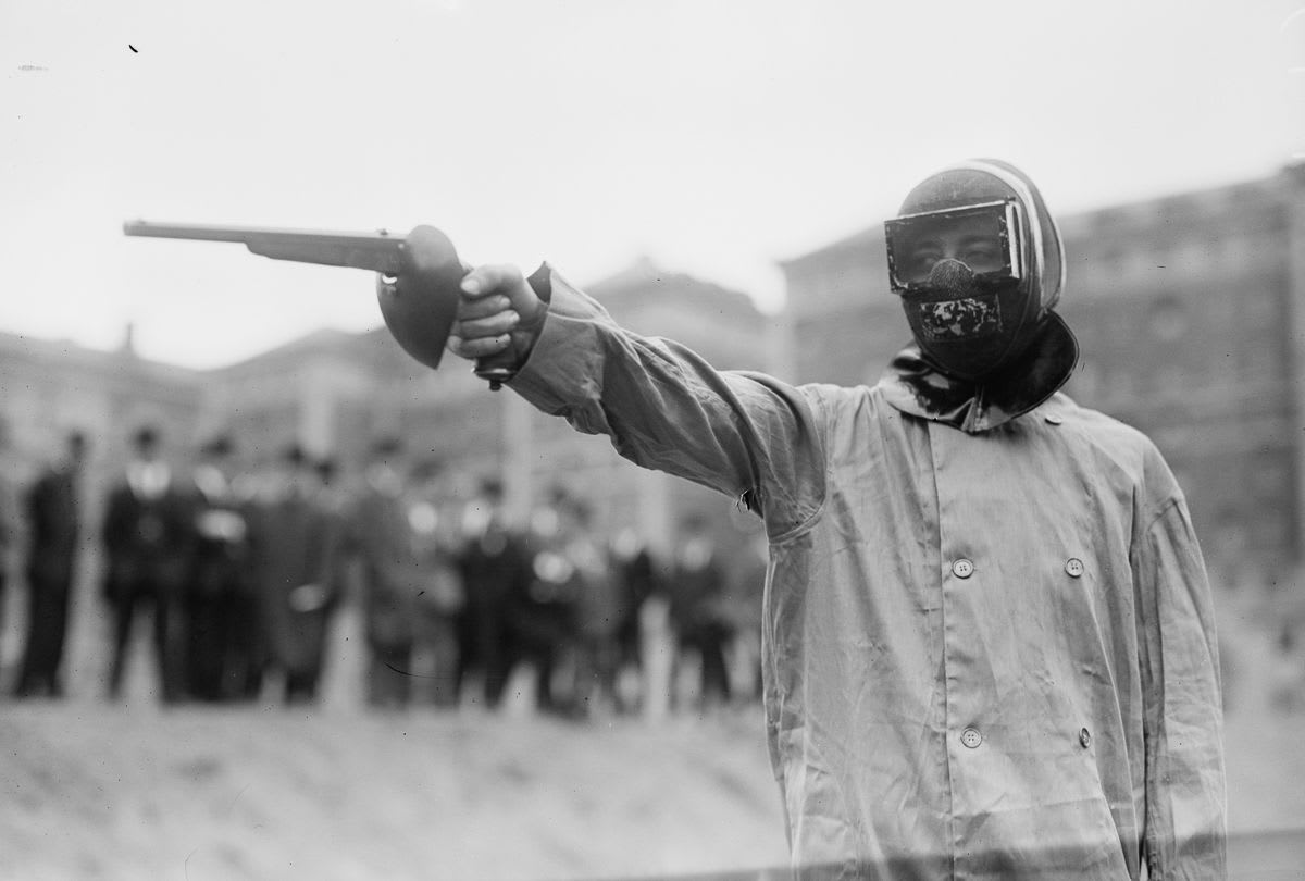 A duelist readying his pistol with wax bullets in the London, 1908 Olympic side event.
