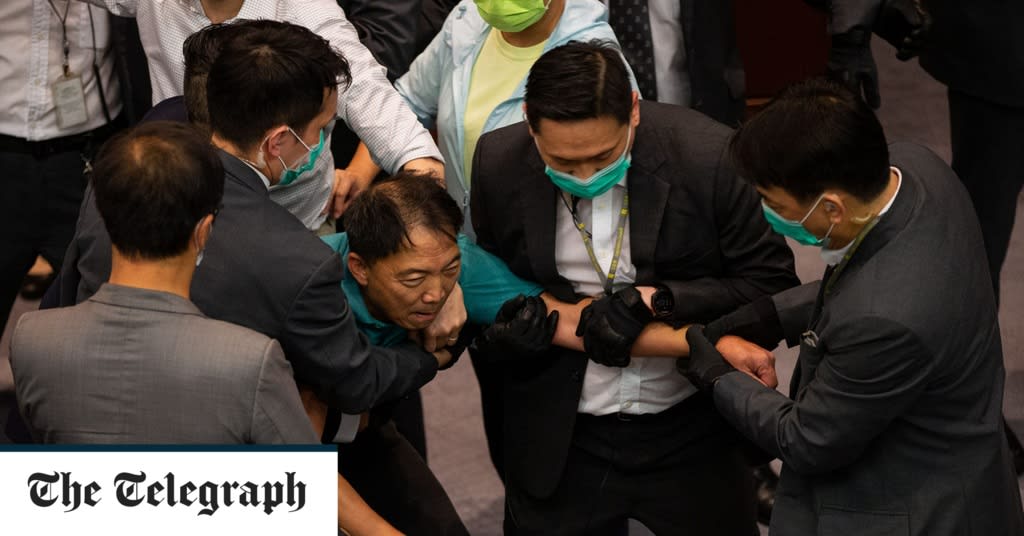 Clashes erupt in Hong Kong legislature as pro-democracy activists charged