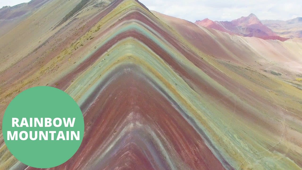 drone footage of psychedelic rainbow mountains in Peru