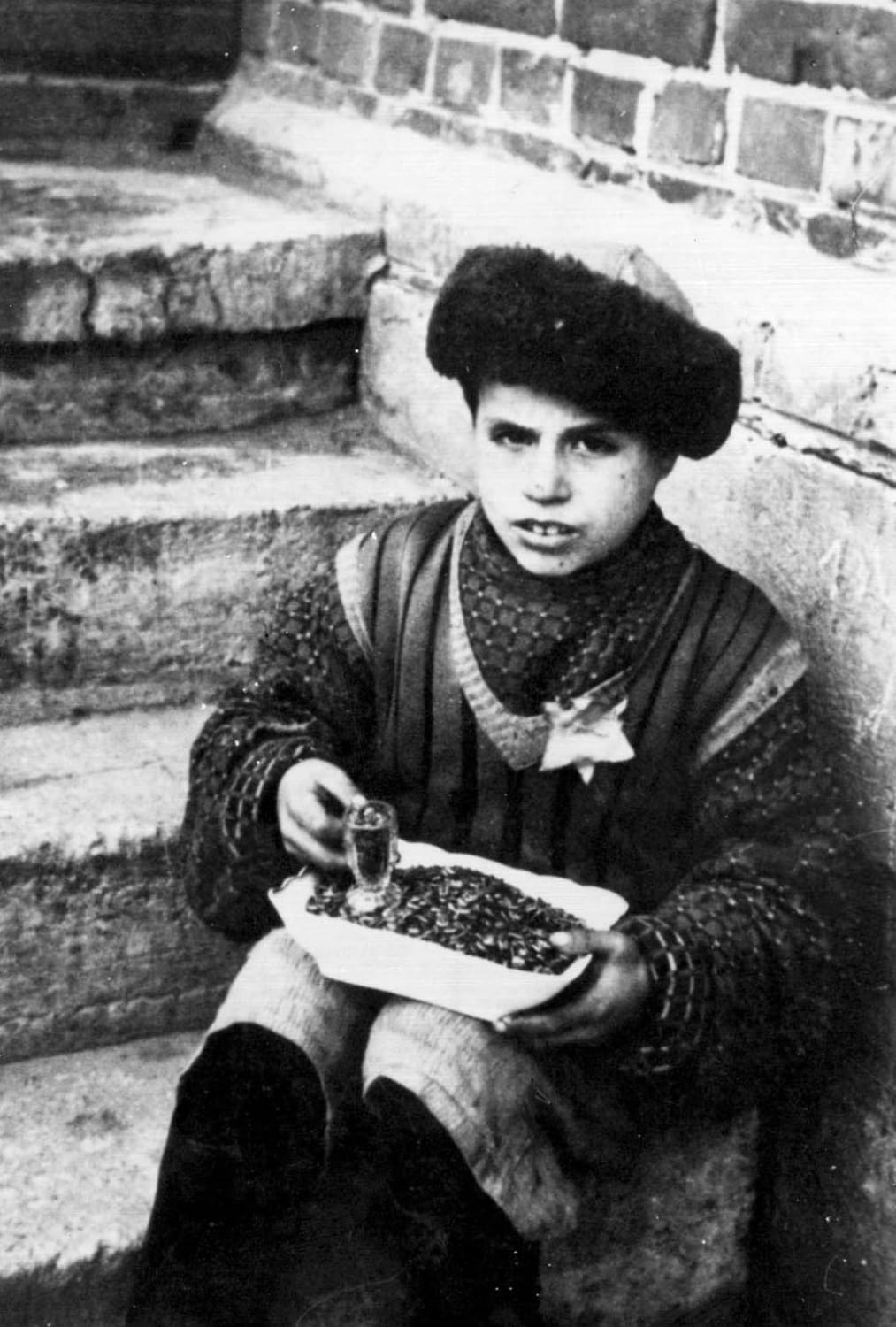 A child selling seeds in the Kovno (Kaunas) Ghetto in Nazi-occupied Lithuania, 1940s.