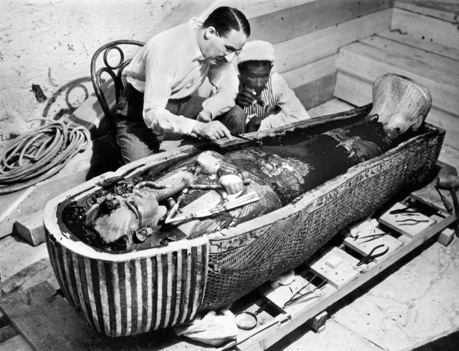 Howard Carter examines the sarcophagus of Tutankhamun 1922.