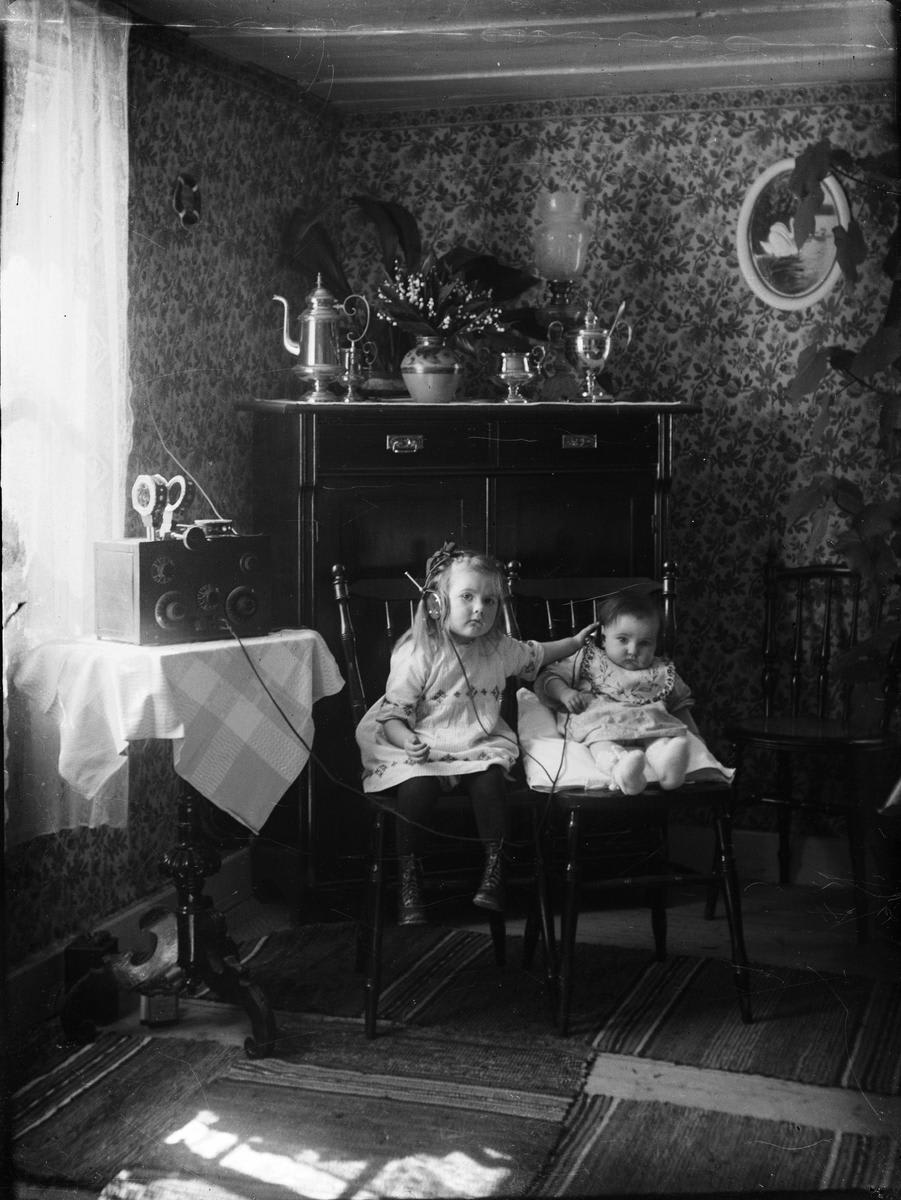 Two sisters listening to the radio. Gryta, Uppland, Sweden in ca. 1925.