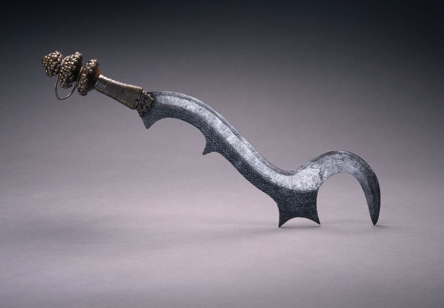 A Ngulu (an execution sword) made by a Ngala artist in late 19th century–early 20th century. From the Democratic Republic of the Congo, now part of the collection of the the Saint Louis Art Museum
