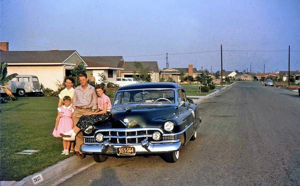Out in the California suburbs, a good looking family posing with their new 1951 Cadillac.