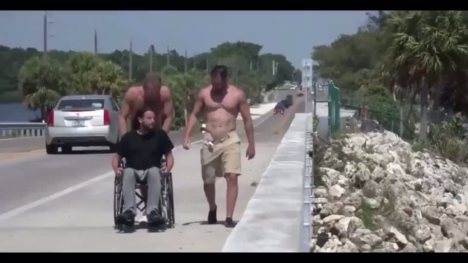 Two buddies take their handicapped friend to see the beach
