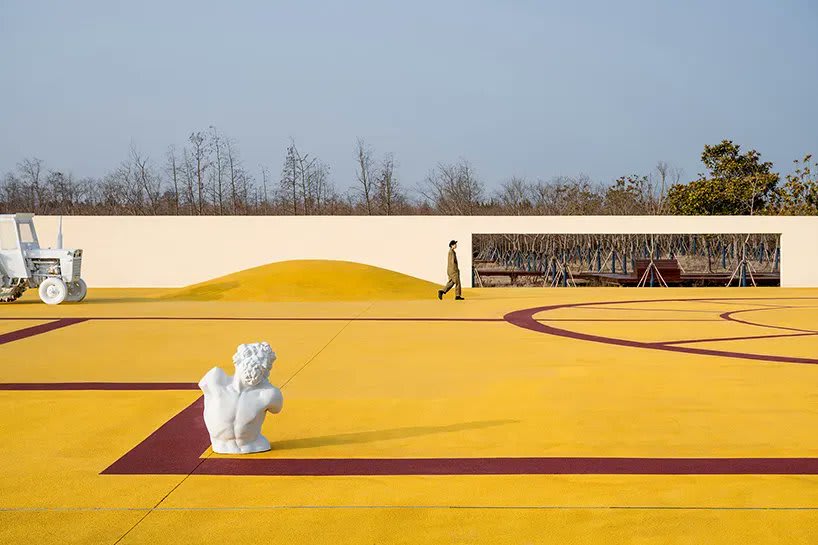 wutopia lab converts disused barnyard into golden yellow haven in shanghai