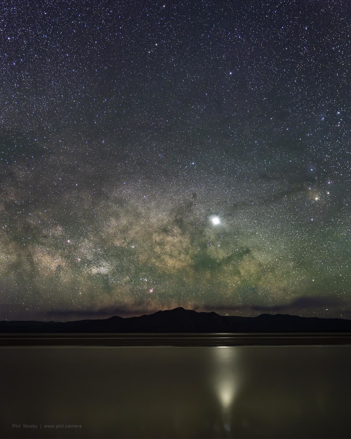 The Milky Way with Jupiter reflecting on the flooded Black Rock Desert, NV. Star-tracked and stitched for maximum detail.
