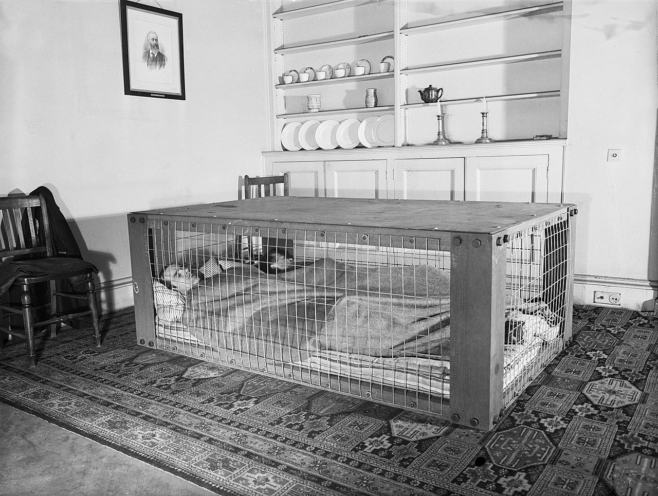 A British couple sleeps inside a “Morrison shelter” used as protection from collapsing homes during the WWII ‘Blitz’ bombing raids. March 1941